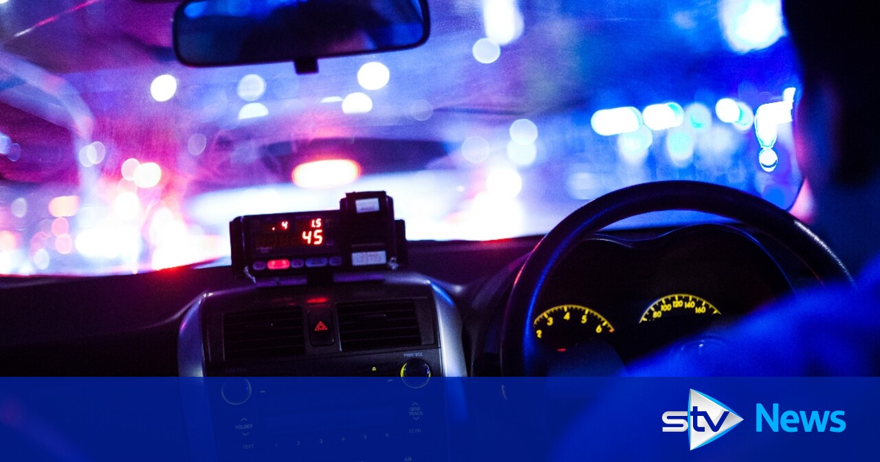 Taxi rank in a UK town with drivers waiting for fares