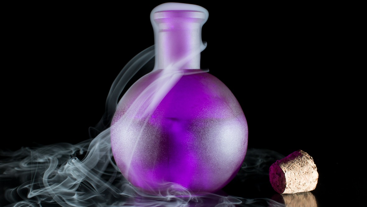 Stock image of purple smoking potion in bottle.
