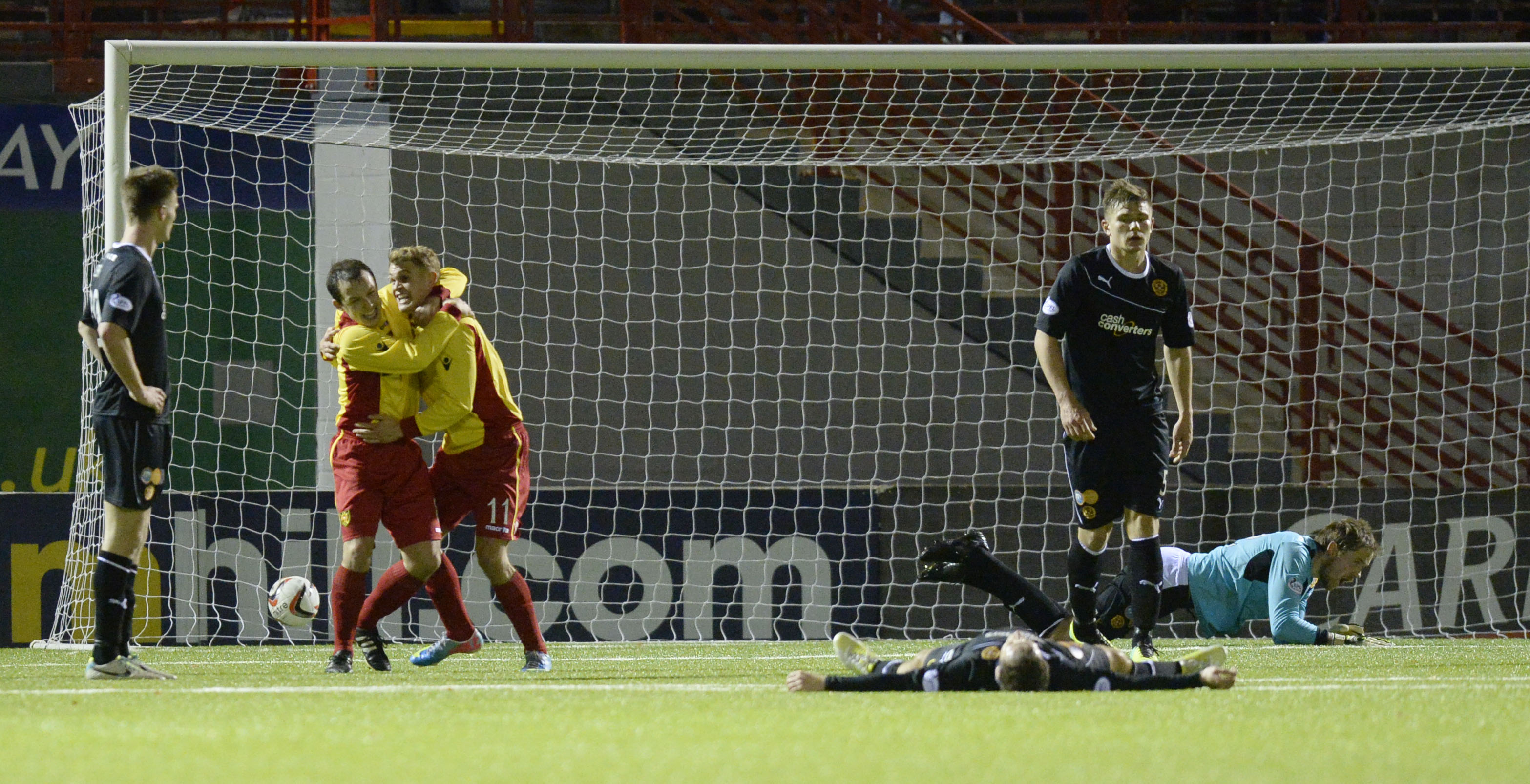 Gary Phillips (third from left) celebrates after scoring in the final minute.
