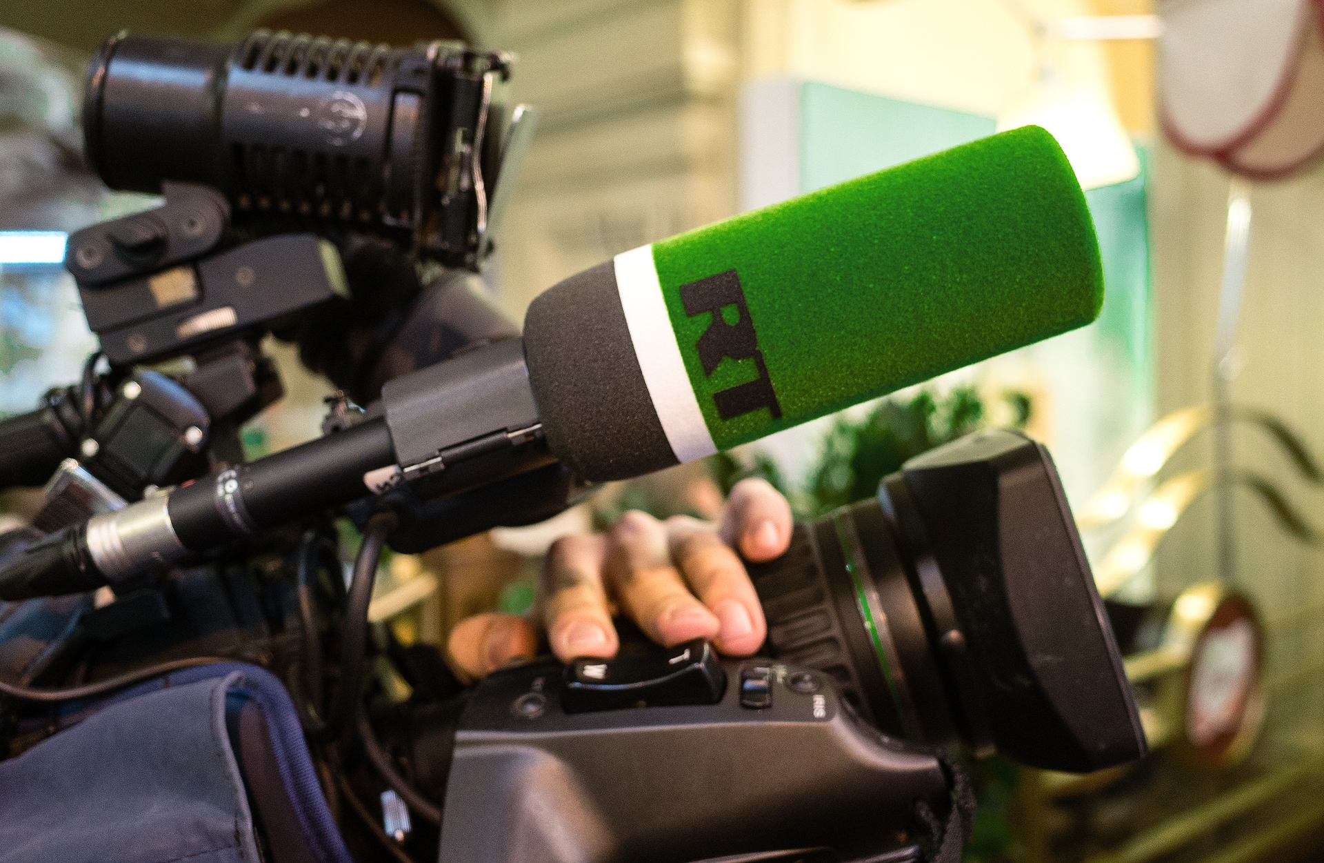 Logo of the TV channel Russia Today on the microphone of a television camera.