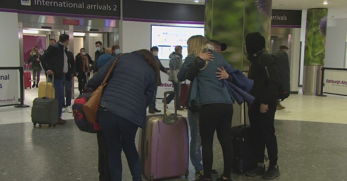 Svitlana Holding and her sons David and Mark are greeted by Cara Reid and her mother at Edinburgh Airport.