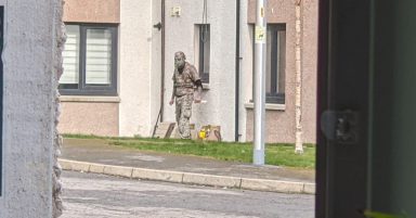 Man in fatigues and gas mask with knives in armed stand-off with police in Polvanie View, Inverness
