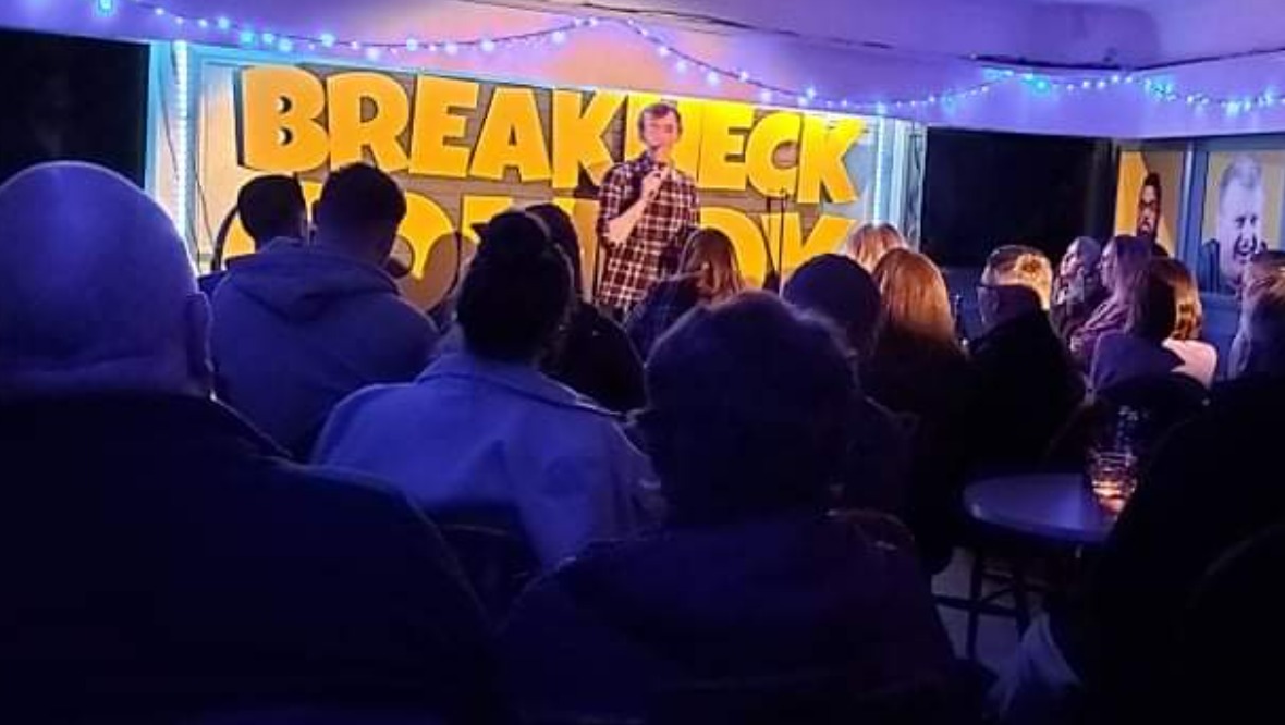 Aiden on stage at Breakneck Comedy Club in Aberdeen.
