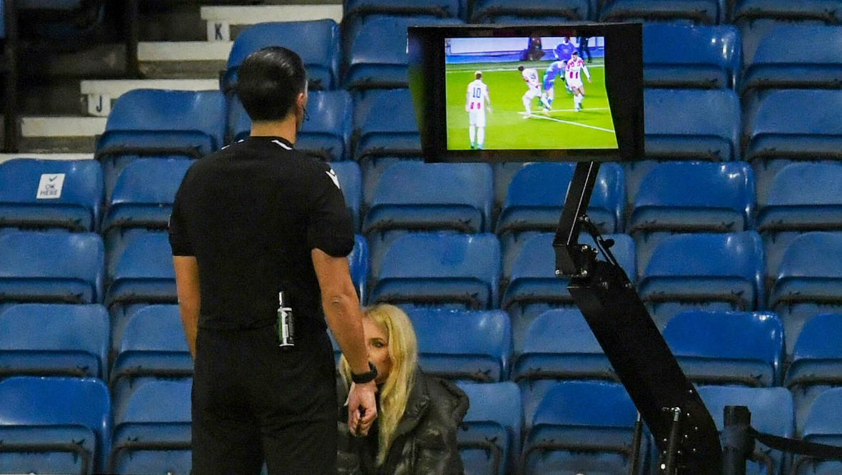 The referee checks the pitchside monitor during Rangers v Red Star Belgrade at Ibrox.