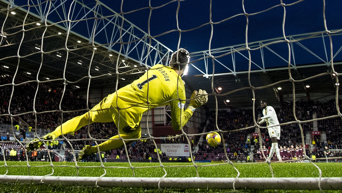 Hearts progressed to the quarter-finals after Craig Gordon saved Ayo Obileye's penalty.