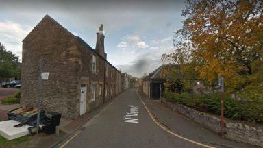 Woman left in serious condition after three intruders broke into Lanark flat in early hours on Monday morning