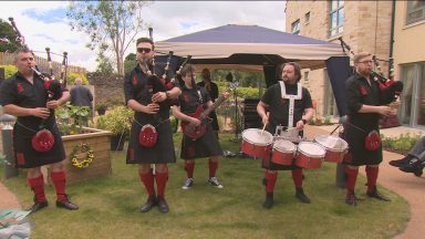 Care home residents have been given a private concert by the most famous bagpipe band in the world