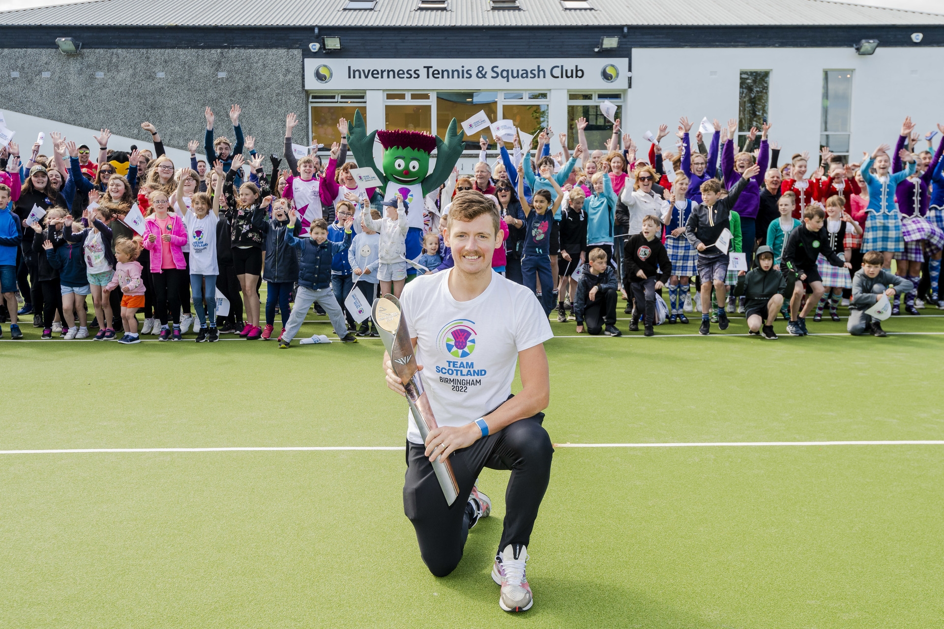 Top Scottish squash player Greg Lobban with the Commonwealth baton