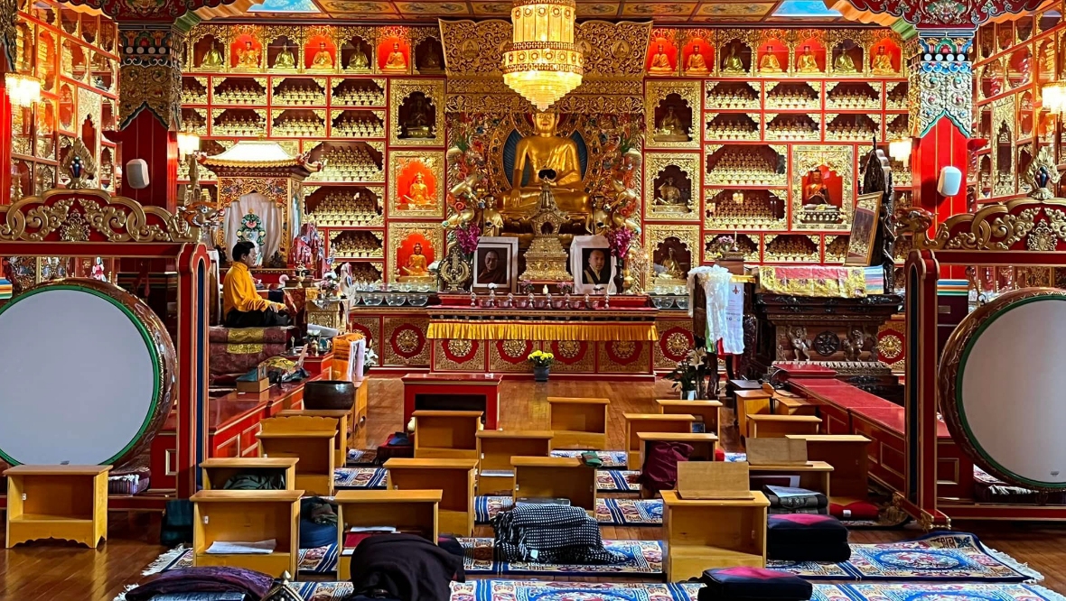 The temple is filled with gold Buddha statues.
