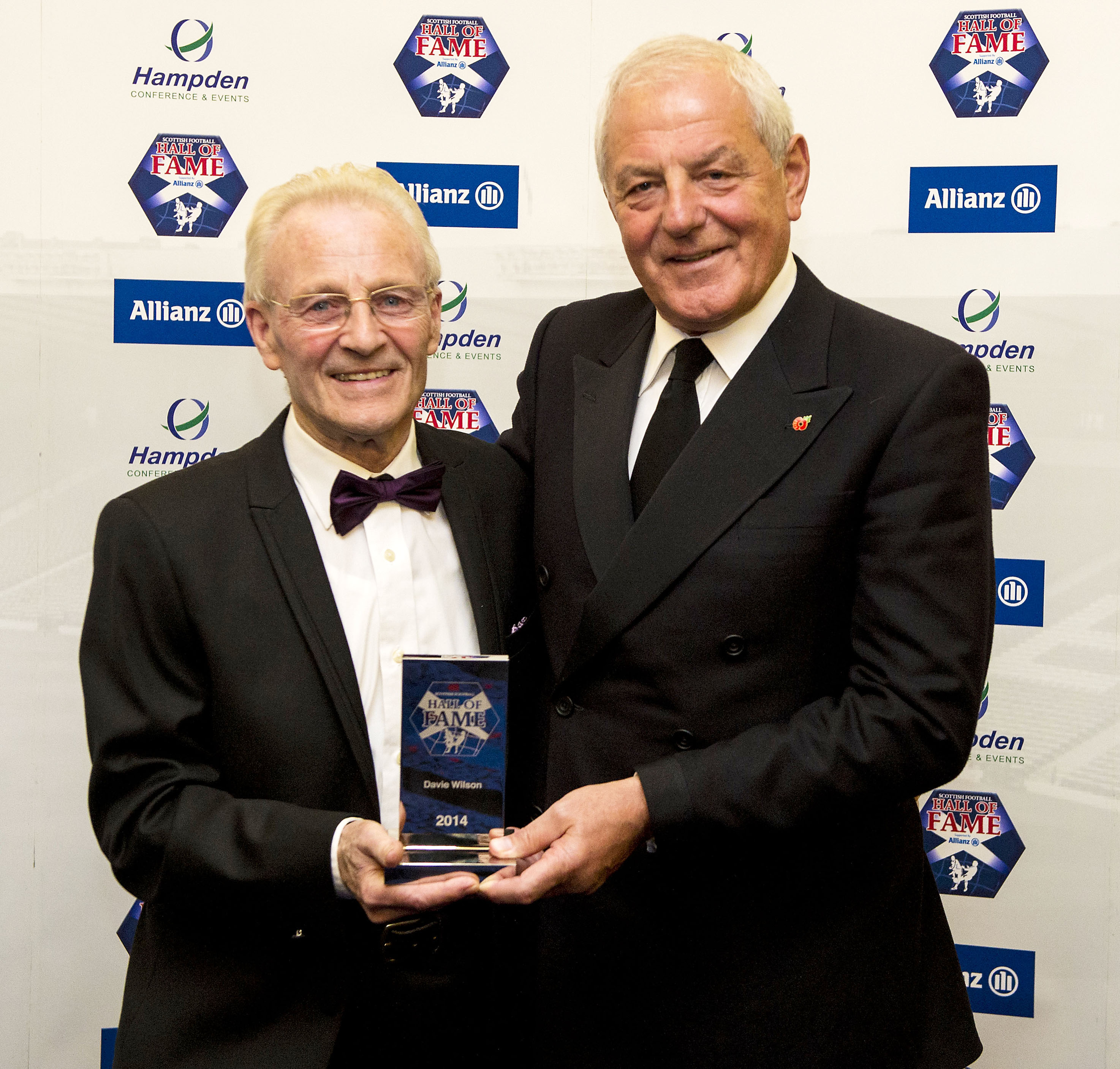 Davie Wilson is presented with his award by former Rangers and Scotland manager Walter Smith as he is inducted into the Scottish Football Hall of Fame in 2014.