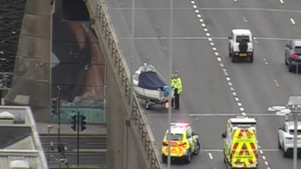 The boat appeared to come loose from a vehicle on the busy bridge.