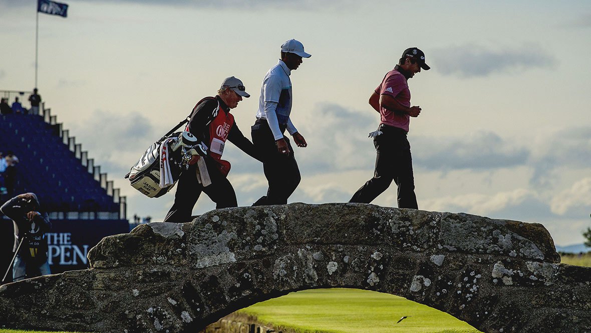 Woods and Jason Day walking over the Swilcan bridge after their round at St Andrews in 2015.