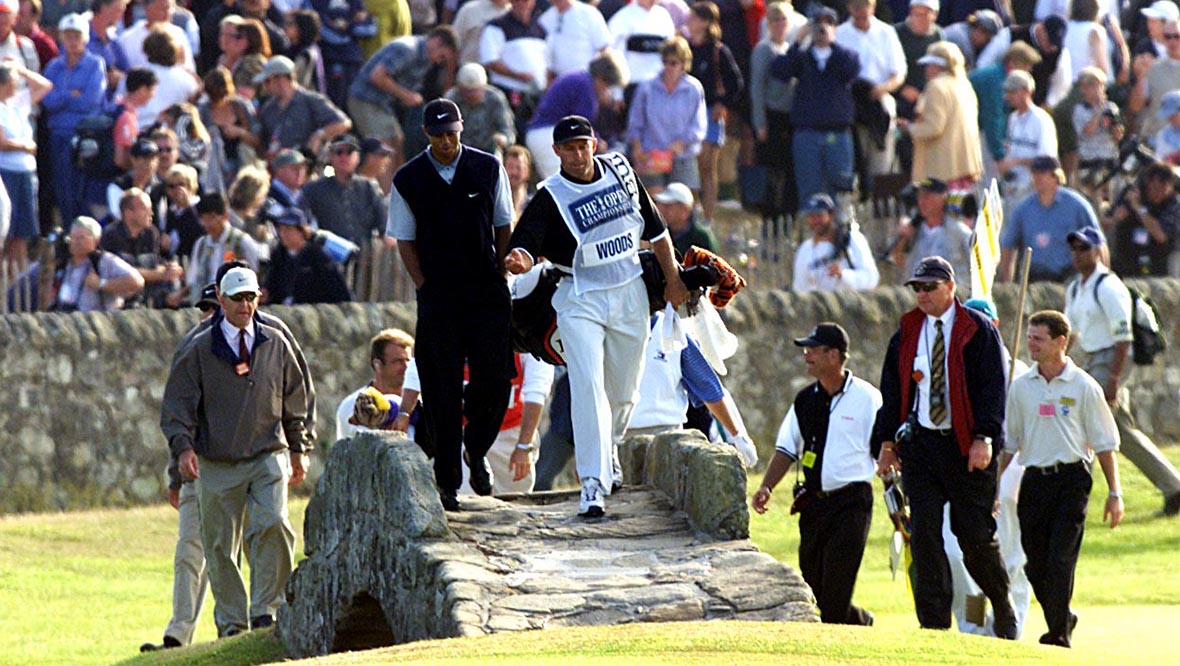 Tiger Woods walking across the Swilcan Bridge to claim the 2000 Open Championship.