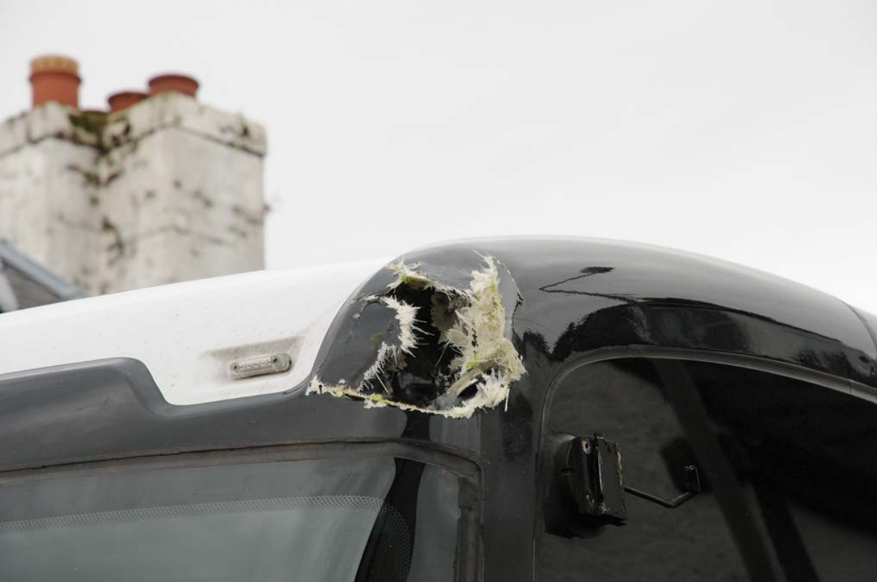 The tour bus struck the arm of the cherry picker. 