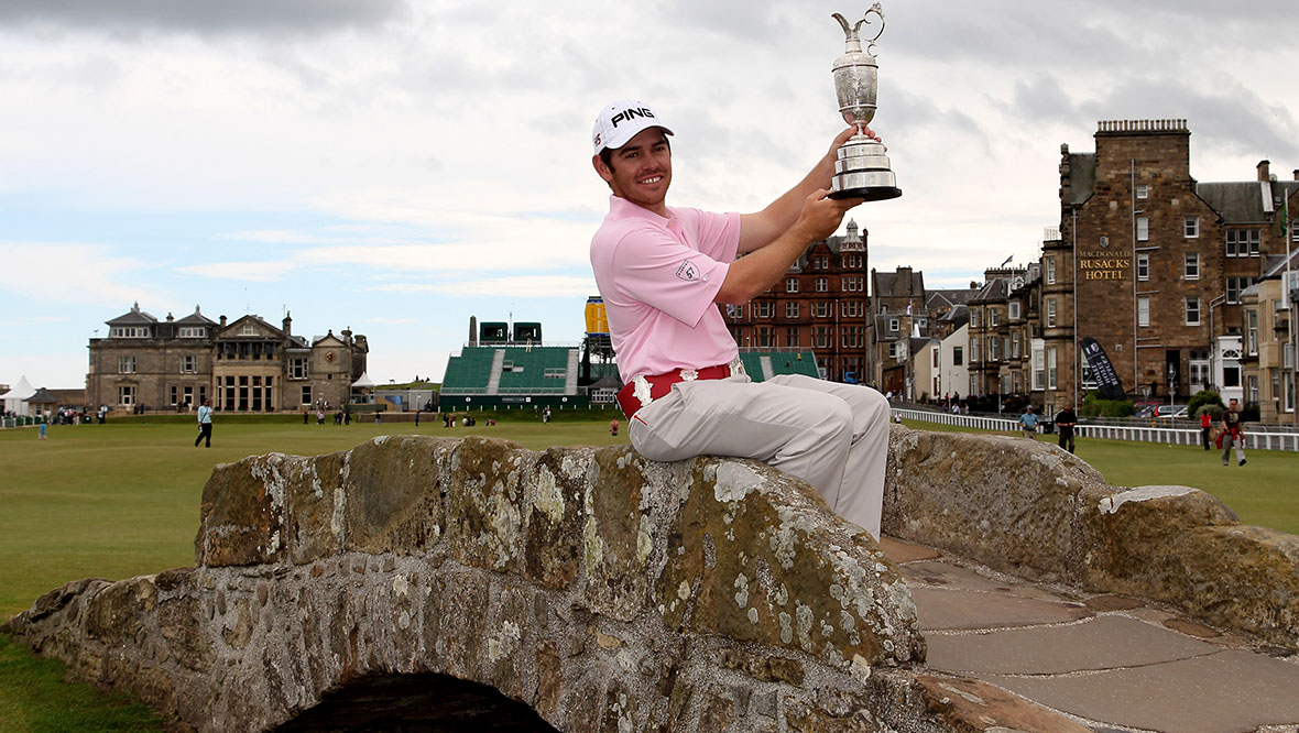 Louis Oosthuizen posing with the Claret Jug on the Swilcan Bridge.