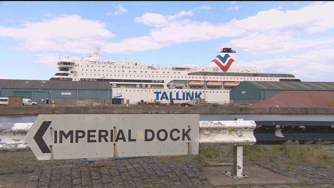 The cruise ship is seen in the background with a sign point to 'Imperial Dock' in the foreground