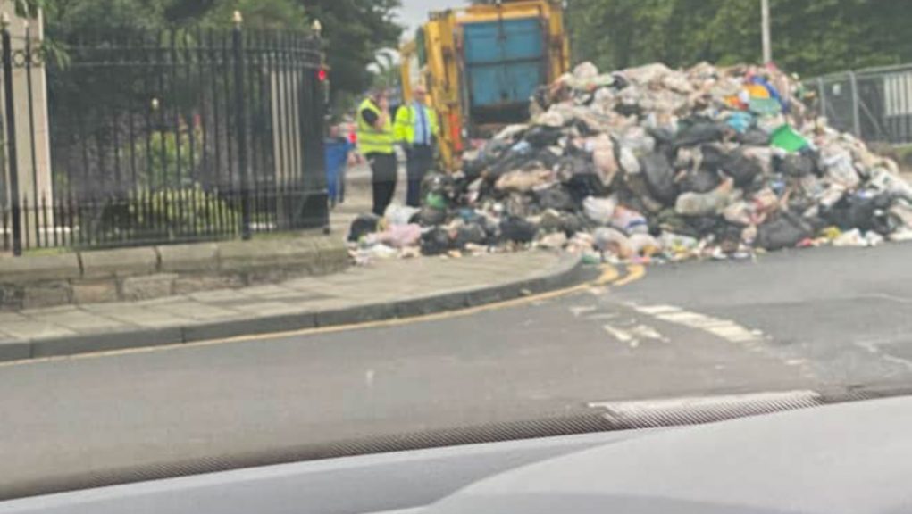 Bin lorry empties rubbish outside police station after fire onboard in