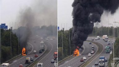 Bus engulfed in huge blaze on M74 motorway as police and fire crews rush to scene