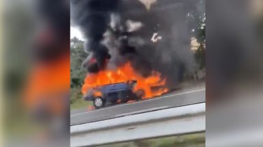 Northbound M90 carriageway near Perth restricted after car bursts into flames