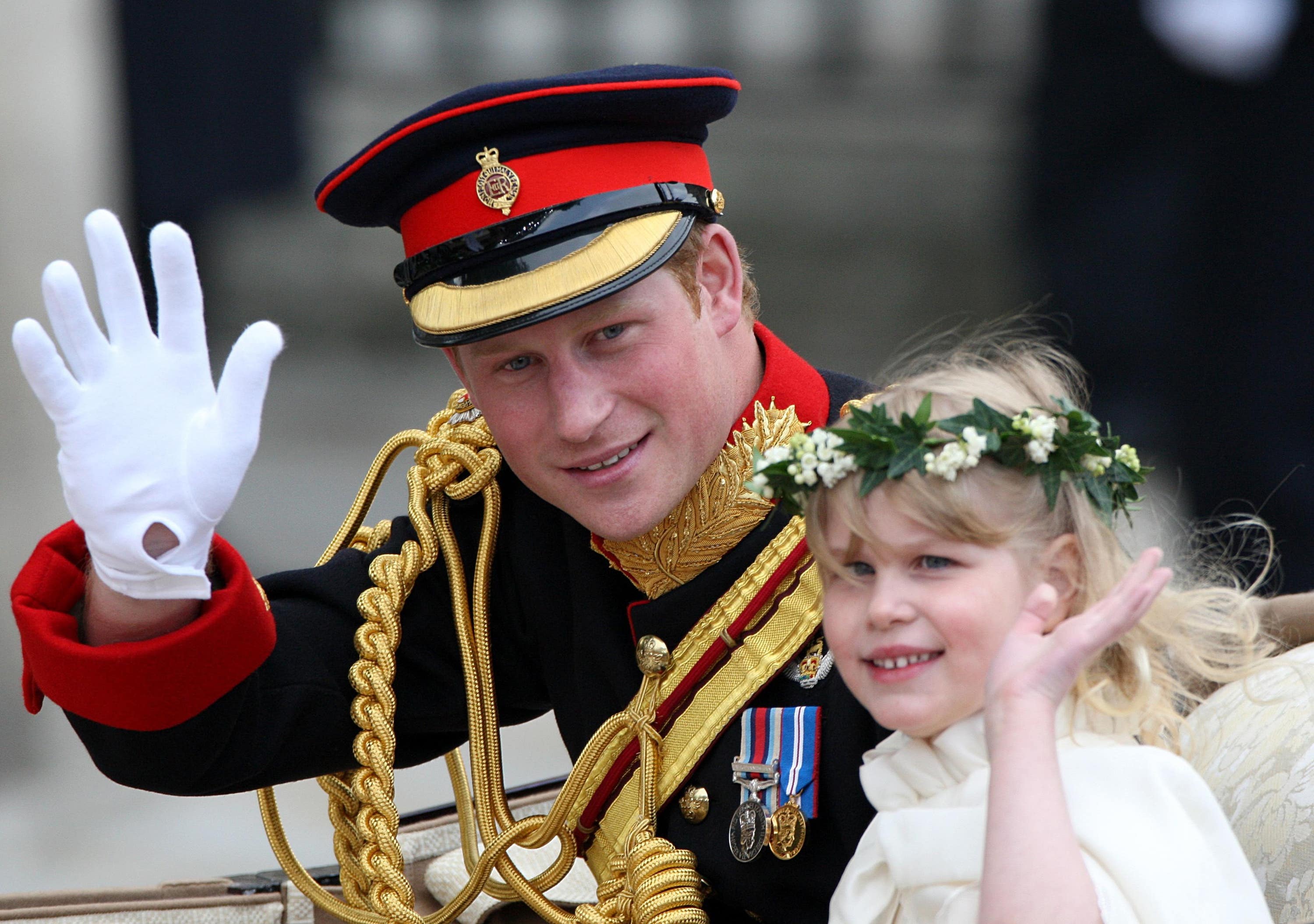 Prince Harry waves to the crowds with Louise after the Cambridges’ wedding.