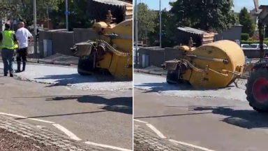 Overturned tanker tips watery grey sludge on busy Aberdeen roundabout