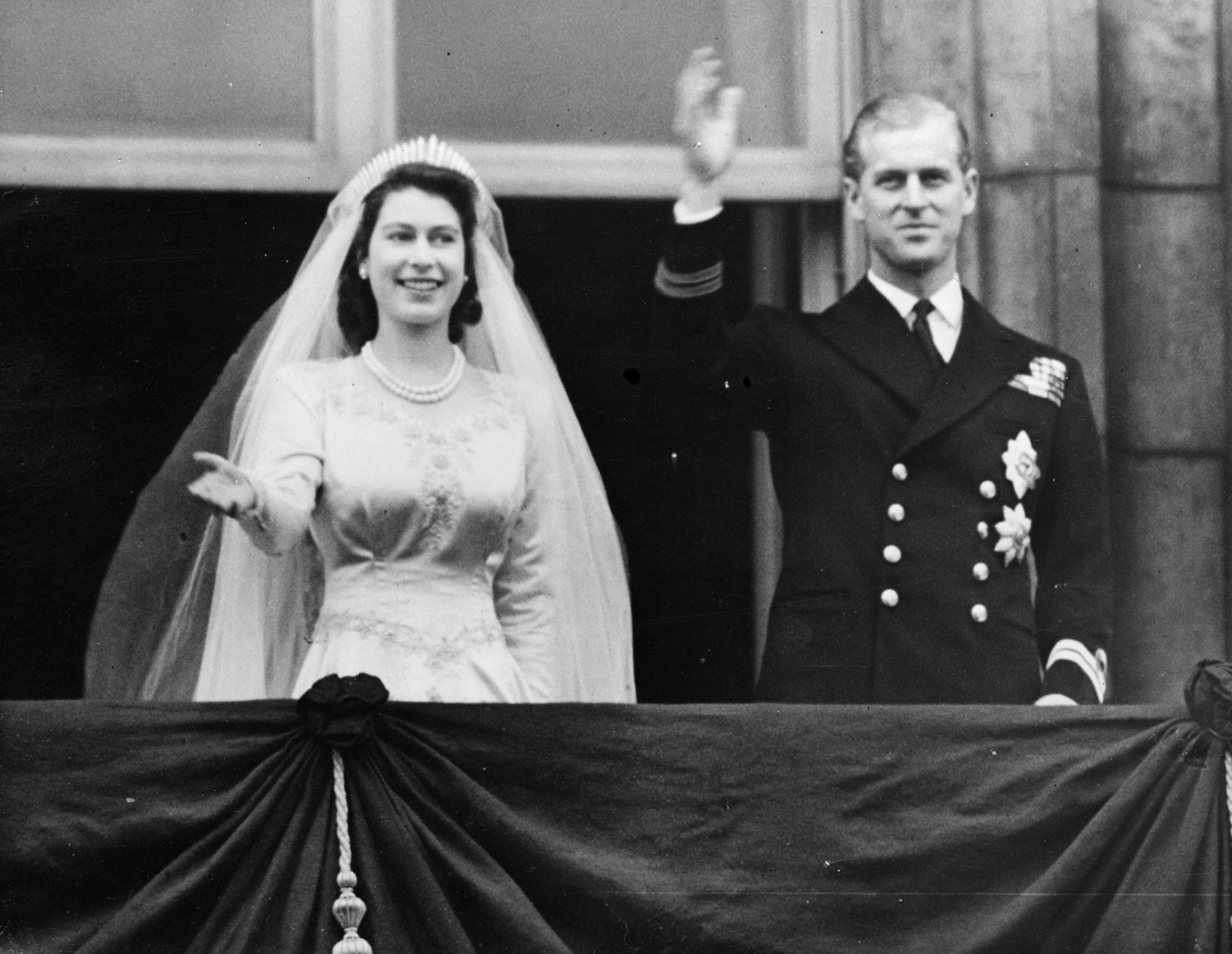 Princess Elizabeth and Prince Philip wave from the balcony of Buckingham Palace shortly after their wedding at Westminster Abbey in 1947.
