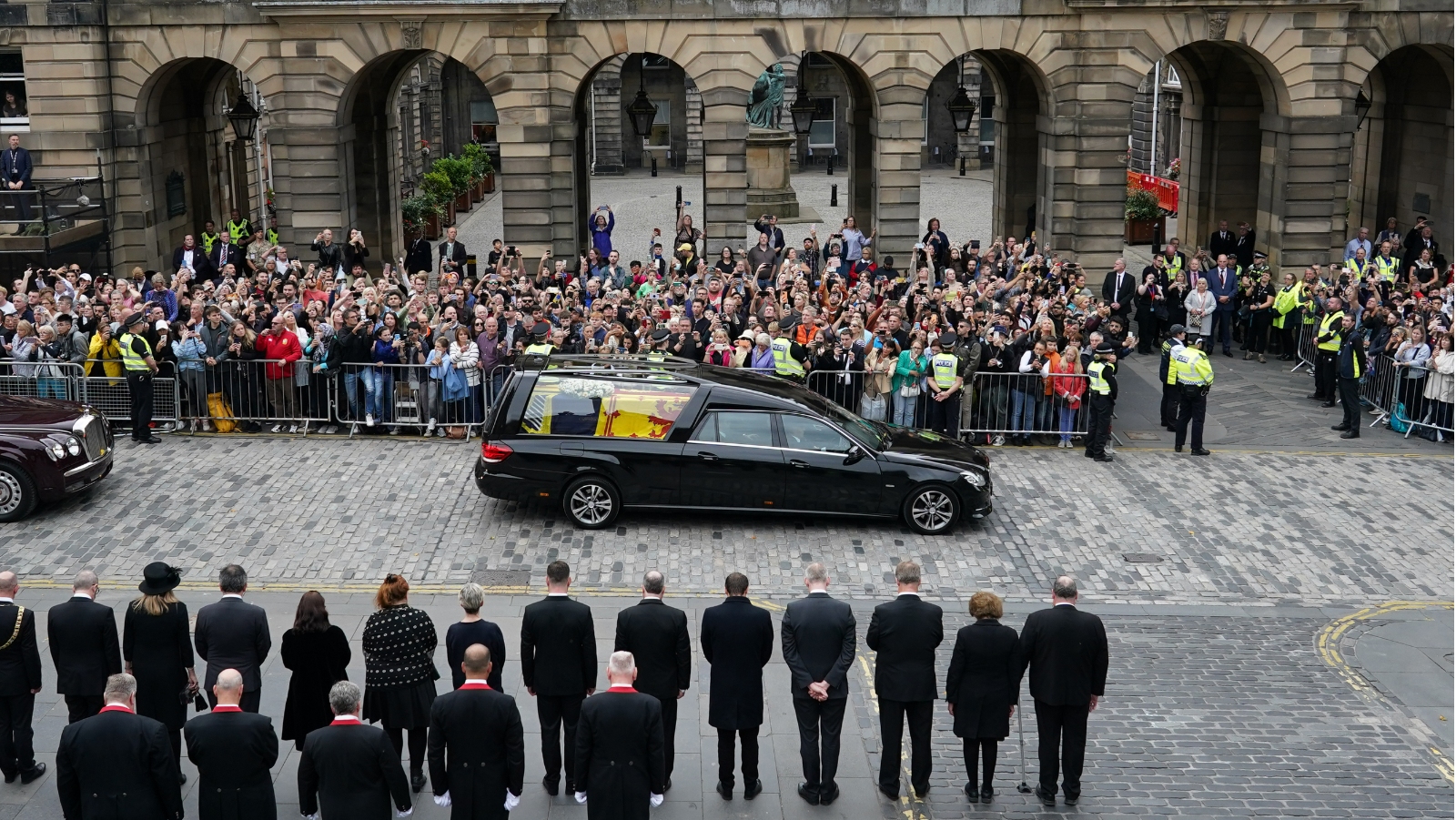 Crowds watch the cortege carrying the Queen's coffin