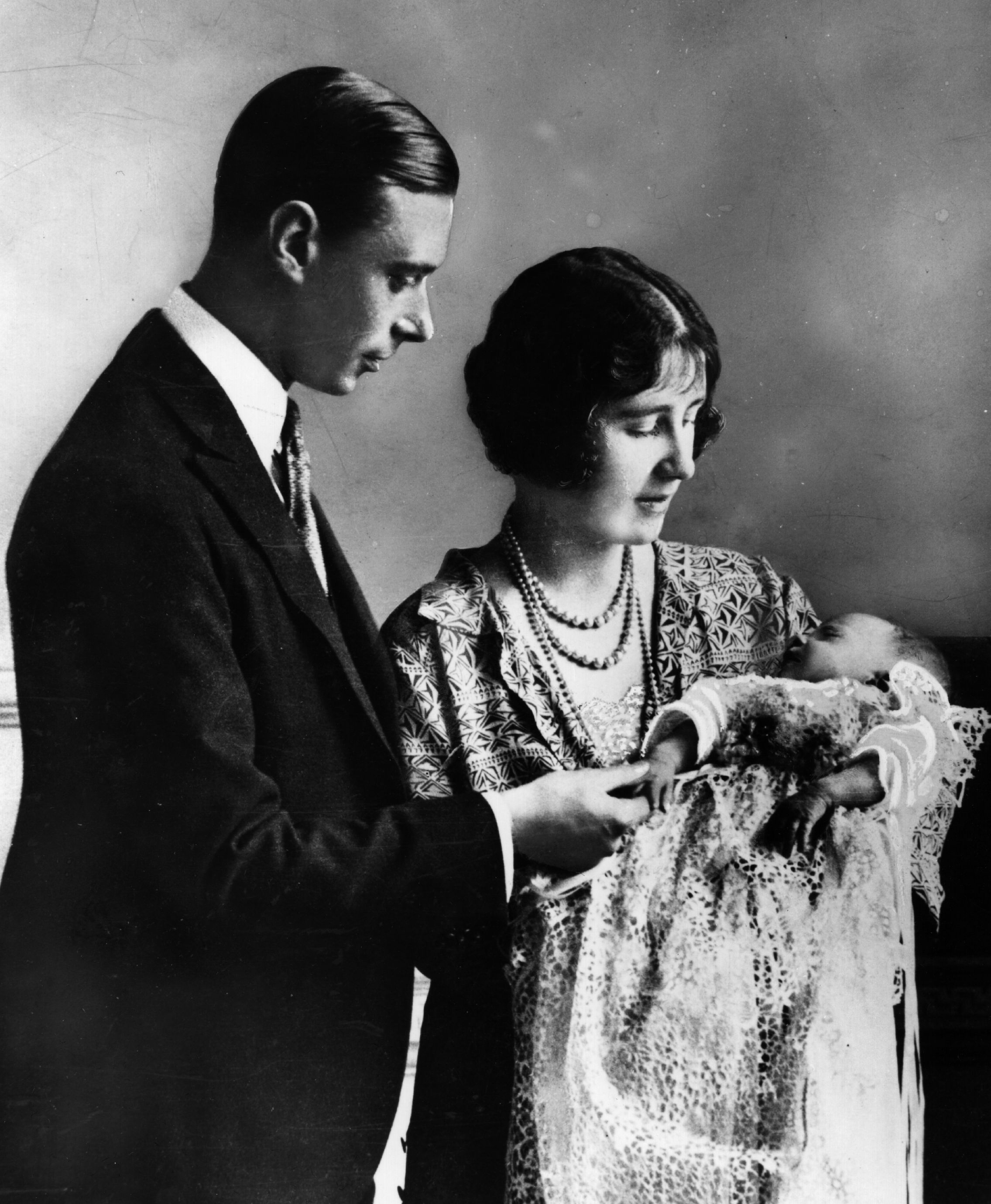 May 1926:  Future King and Queen, George, Duke of York (1895-1952) and Elizabeth Duchess of York (1900-2002) holding their first child, future Monarch Princess Elizabeth, at her christening ceremony.  