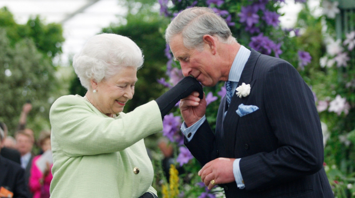 The Queen Elizabeth presents Prince Charles with the Royal Horticultural Society's Victoria Medal of Honour during a visit to the Chelsea Flower Show on May 18, 2009.