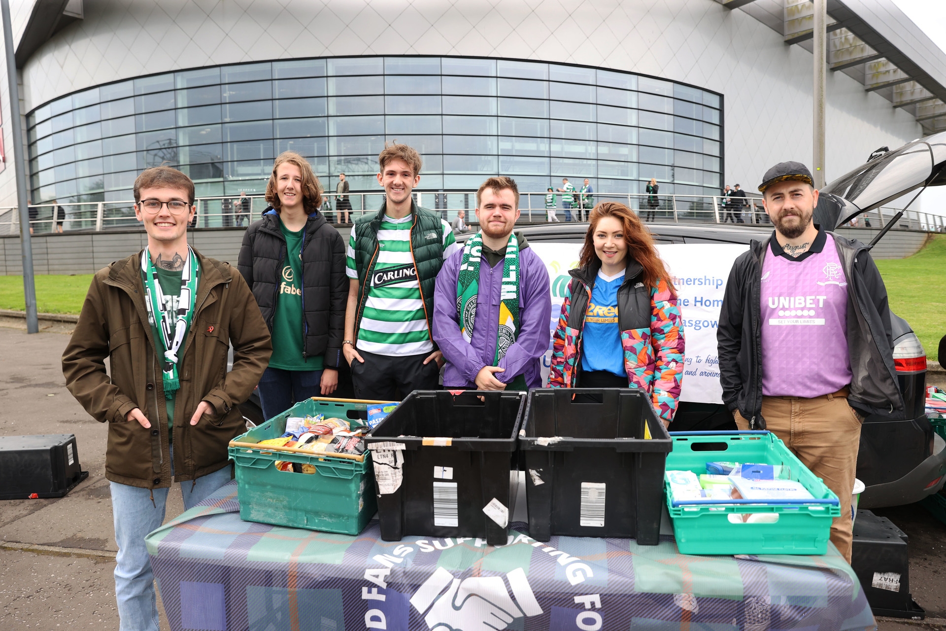 Rangers and Celtic volunteers run a food bank collection at Celtic Park.