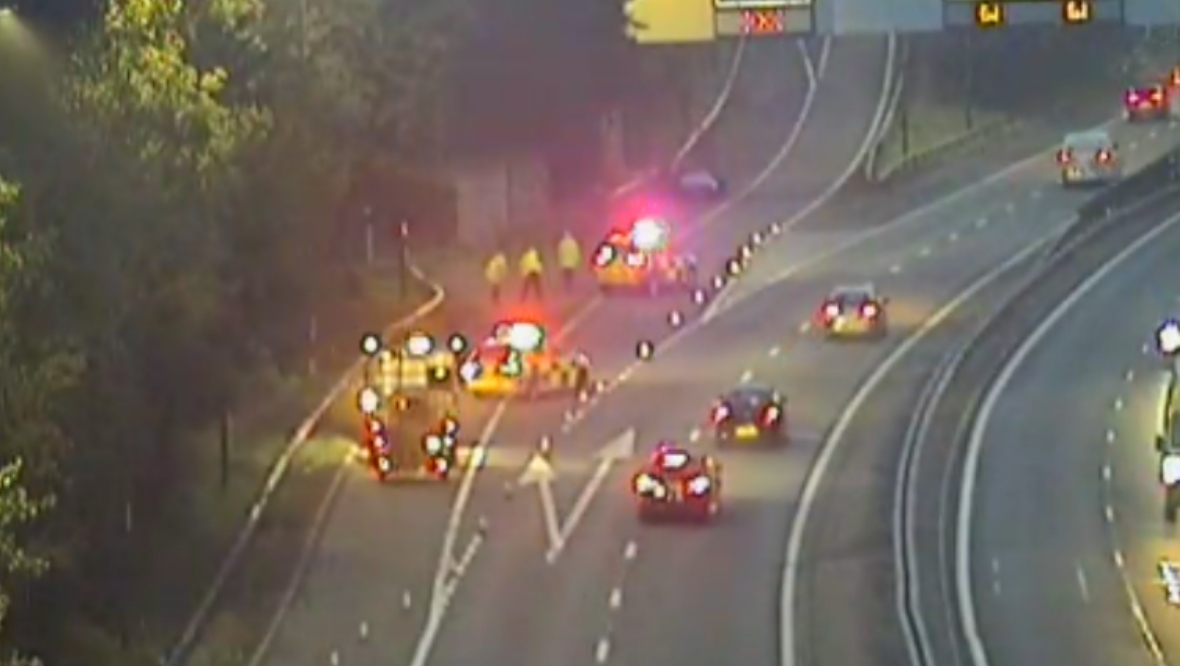 Woman rushed to hospital after early morning crash on M77 as police rush to shut down road
