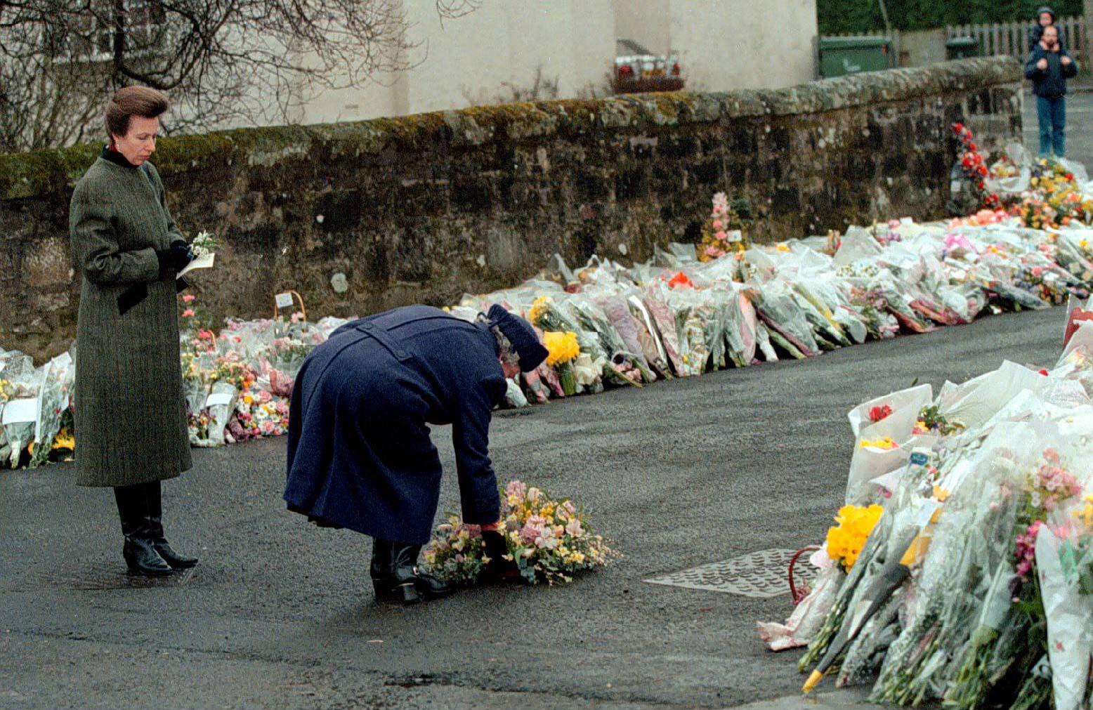 The Queen lays a wreath at the gates of Dunblane Primary School following the massacre.