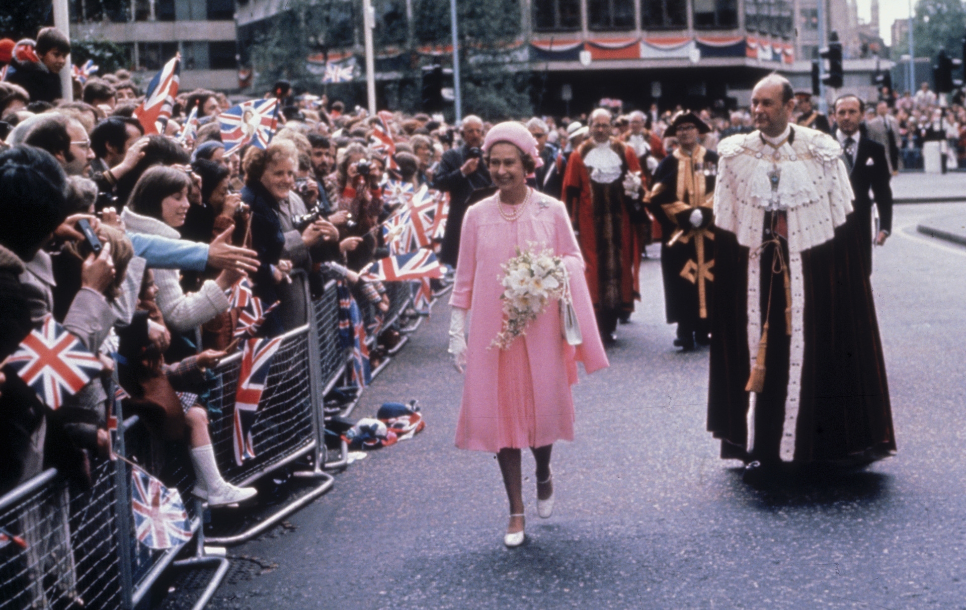 Queen Elizabeth II is greeted by crowds in London during celebrations of her Silver Jubilee on June 7, 1977. She is accompanied by the Lord Mayor of London, Sir Robin Gillett (right). 
