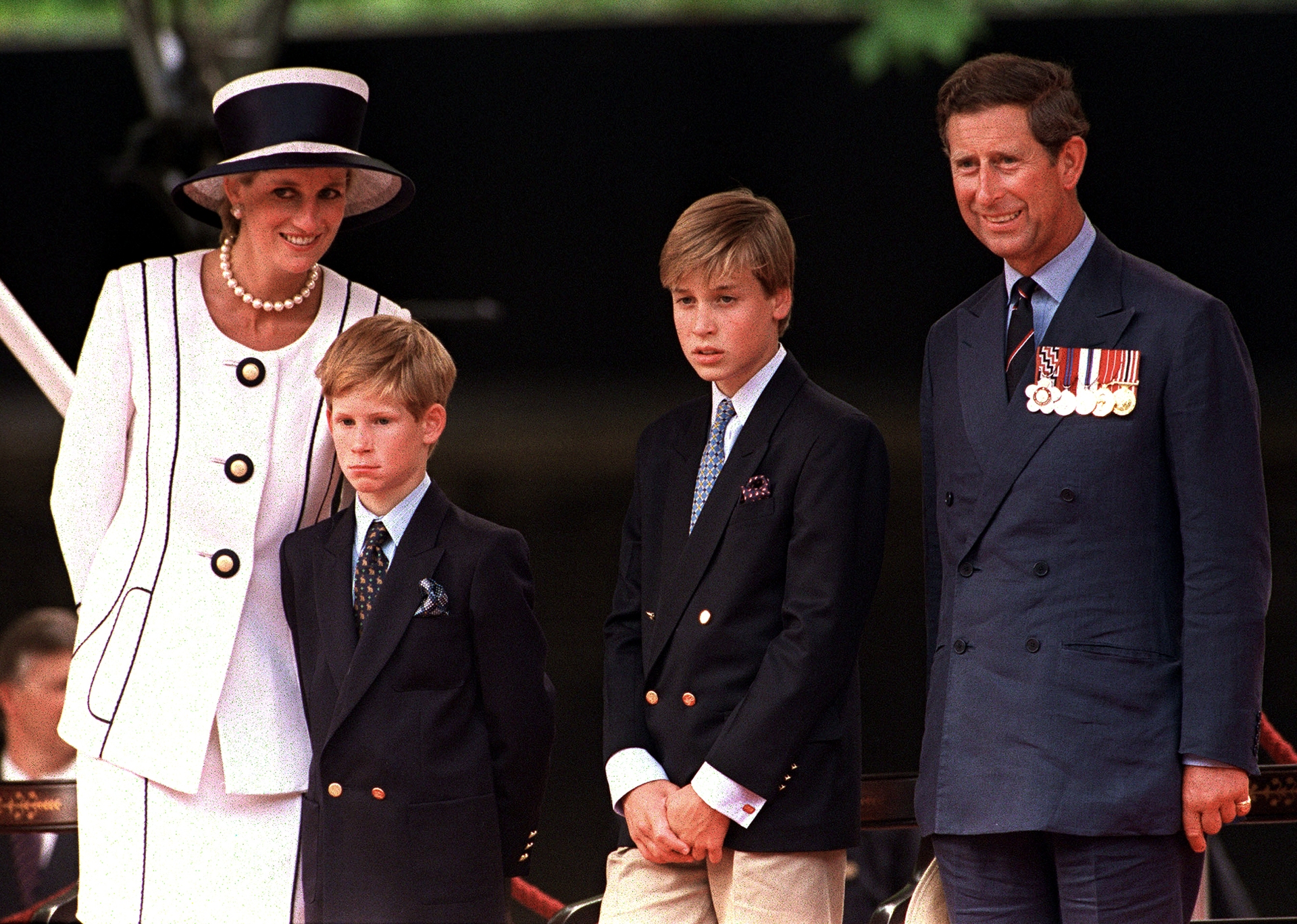 Prince Harry, Prince William and Prince Charles at a parade in the Mall, London, during V.J. Day commemorations in August 1994.