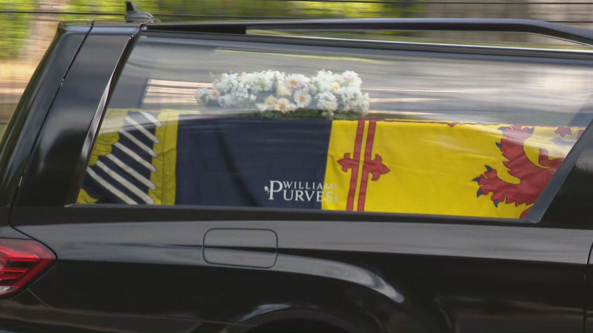 The coffin was draped in the Scottish version of the Royal Standard.