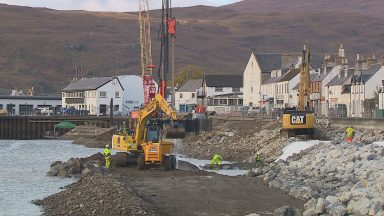 Worker underway to rejuvenate Ullapool harbour and promenade