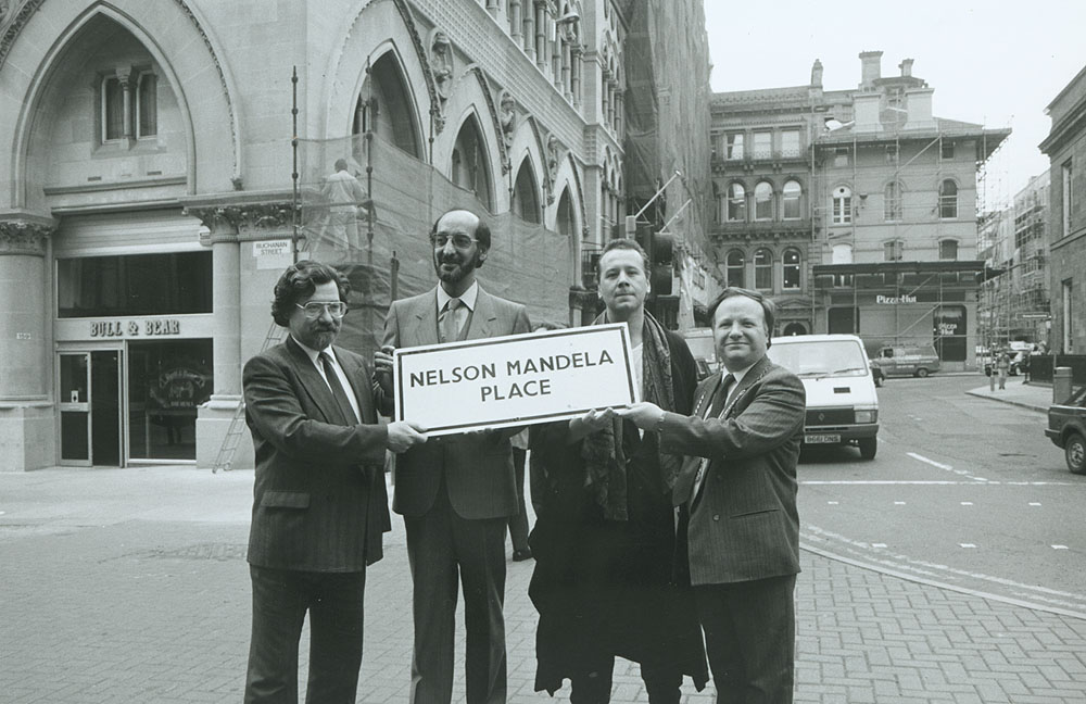 Brian Filling, Ismail Ayob, Jim Kerr and councillor Danny Crawford, with a sign for Nelson Mandela Place.