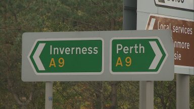 Signpost is seen on the A9 road, directing drivers to either Inverness or Perth