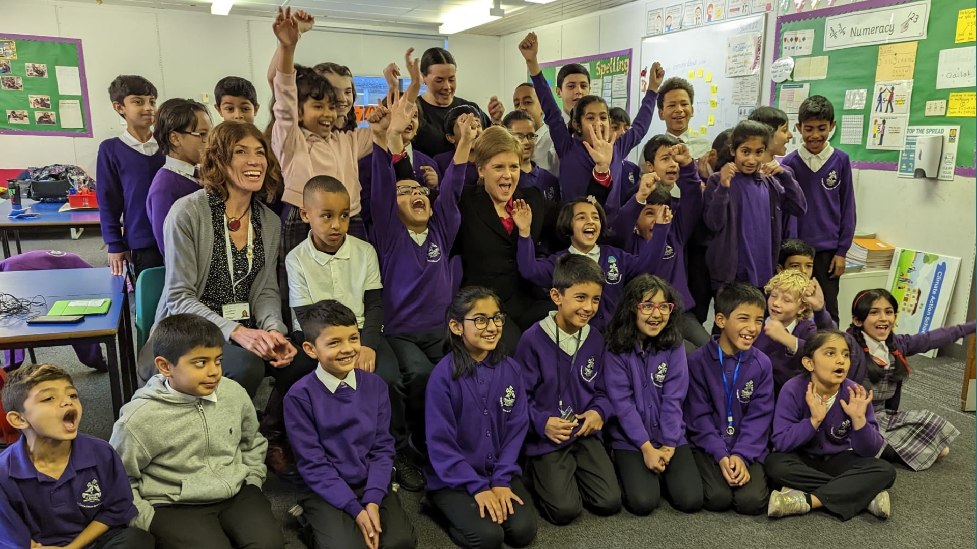 A photo of the First Minister with pupils was targeted with racist abuse. 