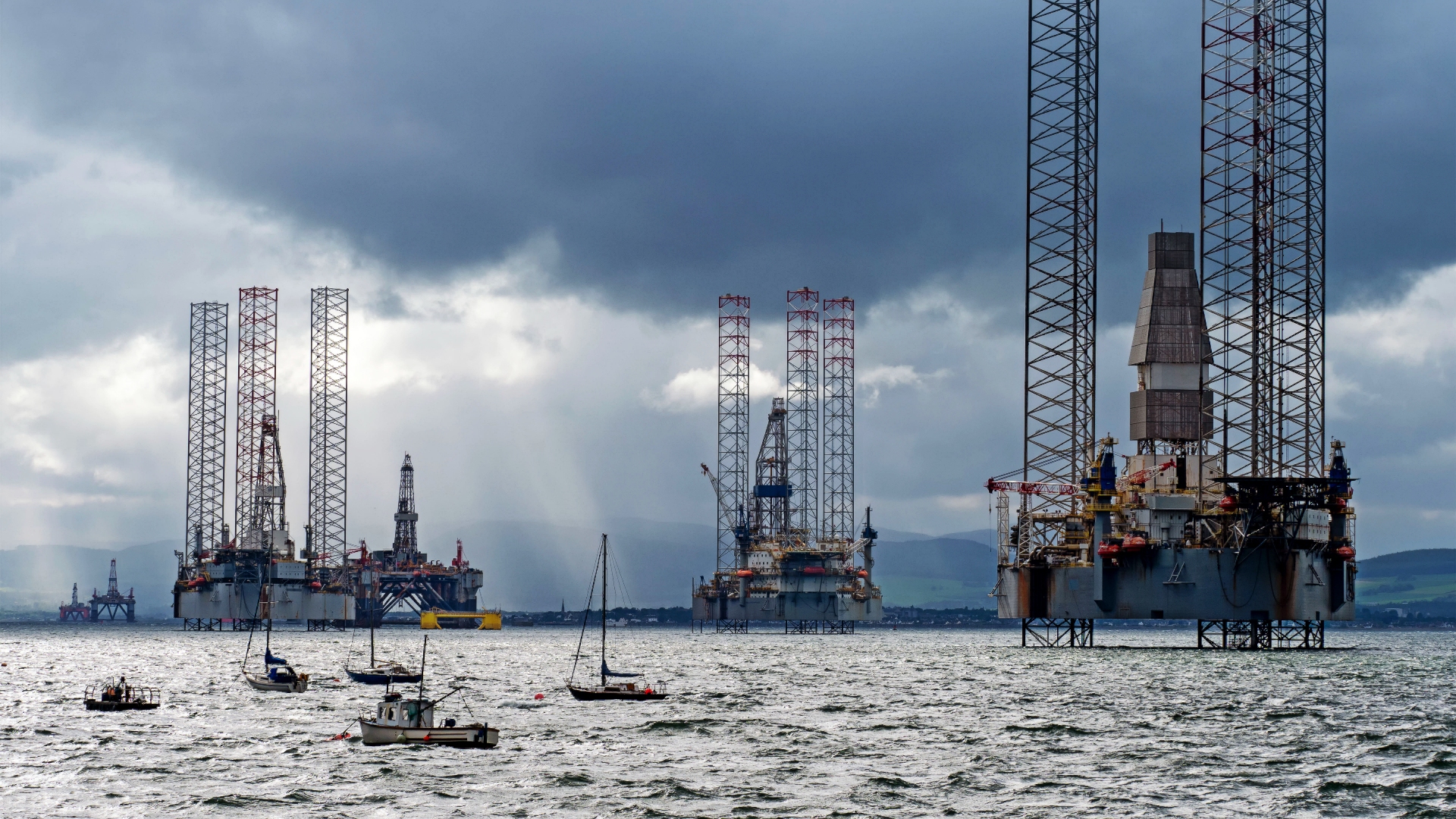 Oil rigs moored in the shallow waters of the Cromarty Firth in Scotland.