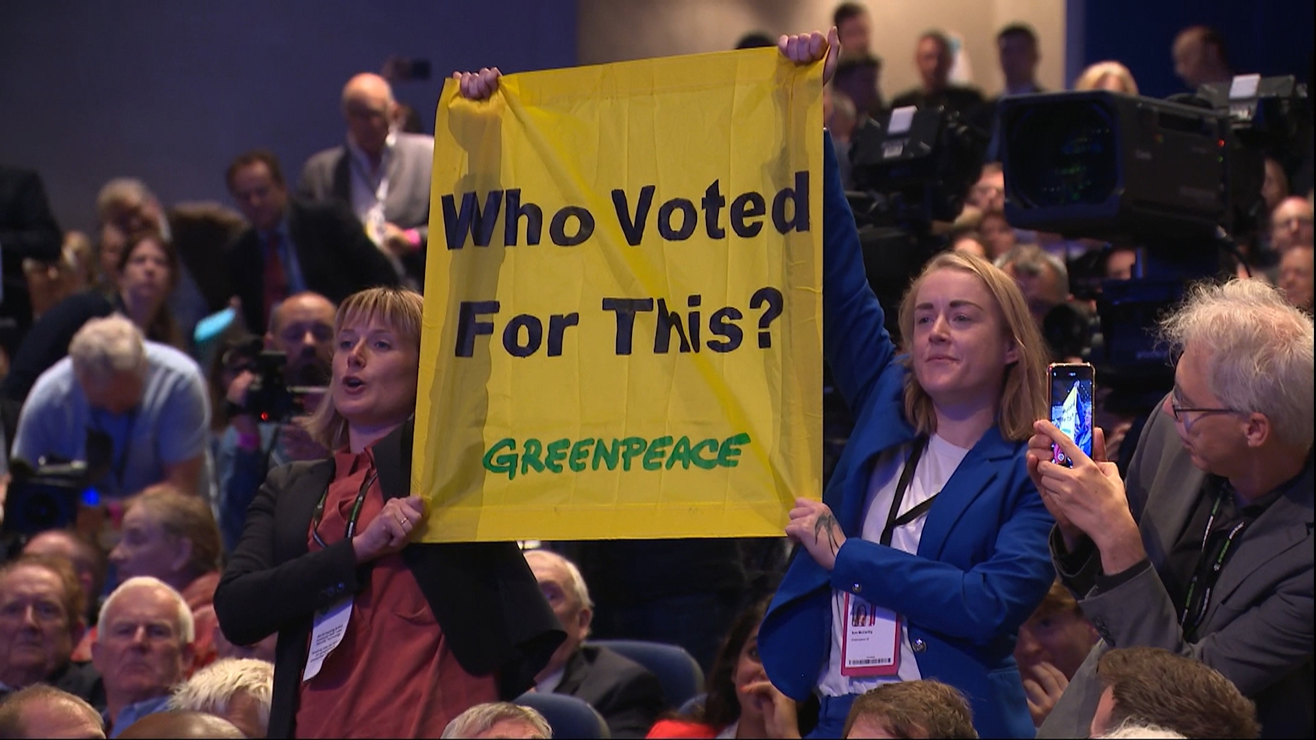 Greenpeace protesters during Liz Truss' conference speech.
