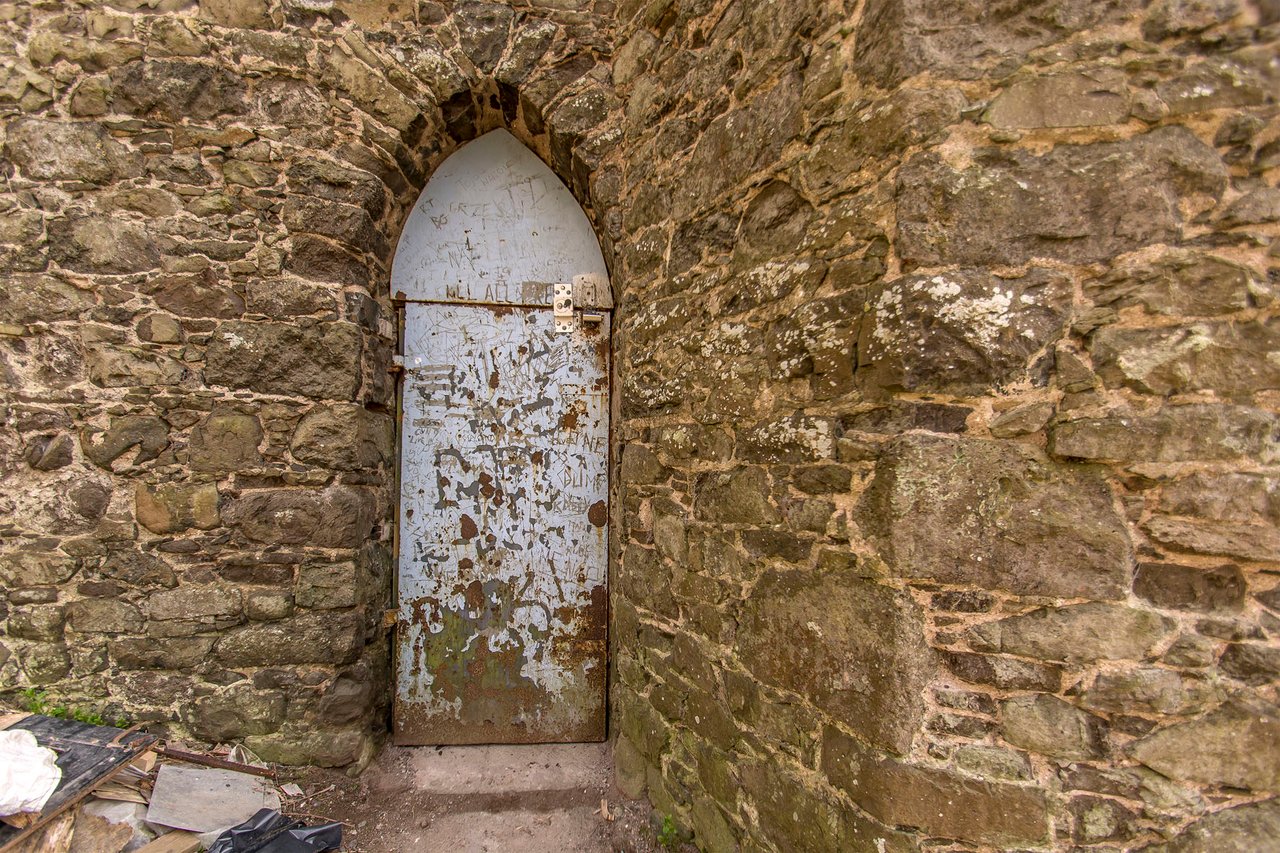 Entrance through an arched doorway to Binnhill Tower