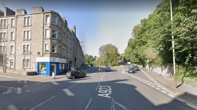Man arrested and woman rushed to hospital following two-car collision on Lochee Road in Dundee