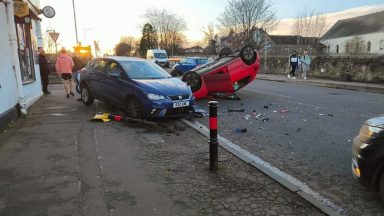 Car flipped on to its roof after collision with parked vehicle in Cowdenbeath