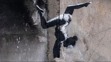 Banksy unveils artwork on side of partially-destroyed building in Ukraine