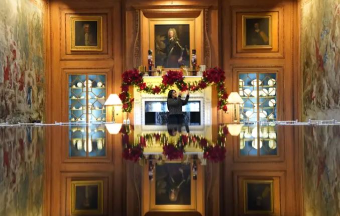 Collections manager Satinder Kaur checks the Christmas displays in the Tapestry Room.