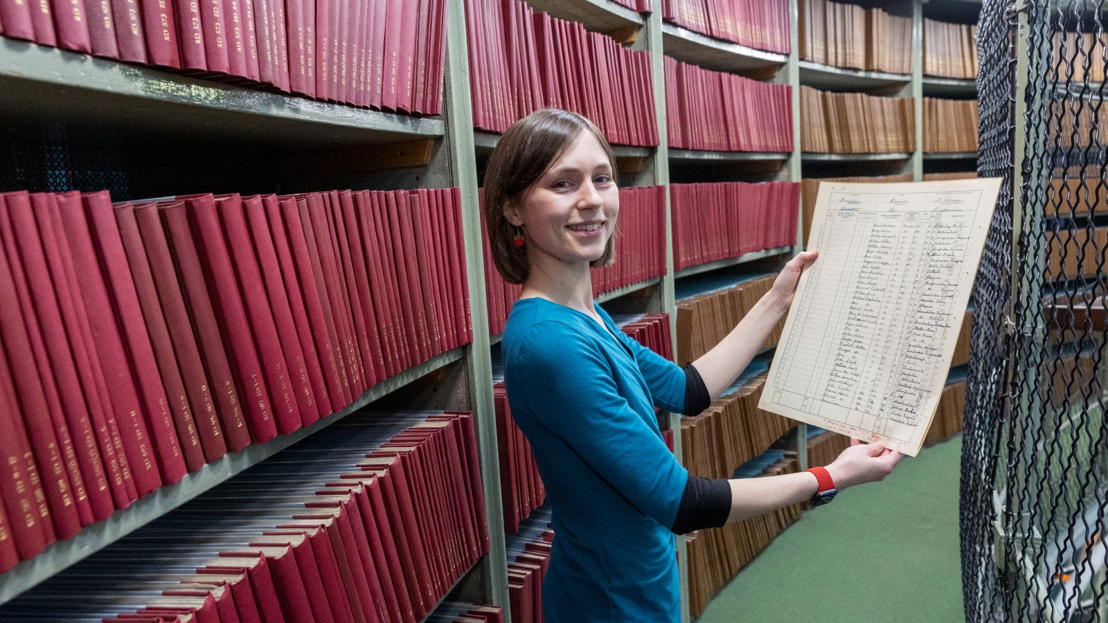 NRS Archivist Jocelyn Grant in New Register House Dome with a page from the 1921 census.