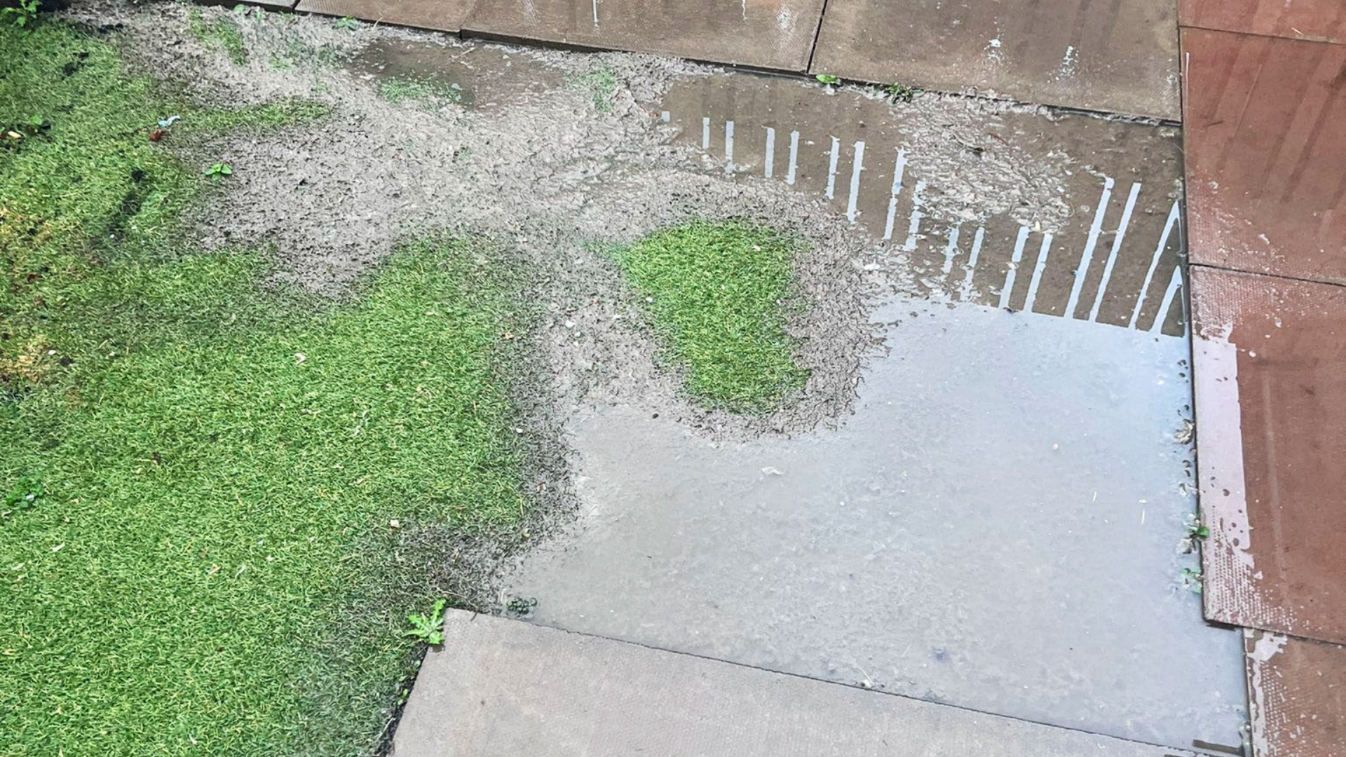 Flooded slabs and artificial grass in Daryl Murray's garden.