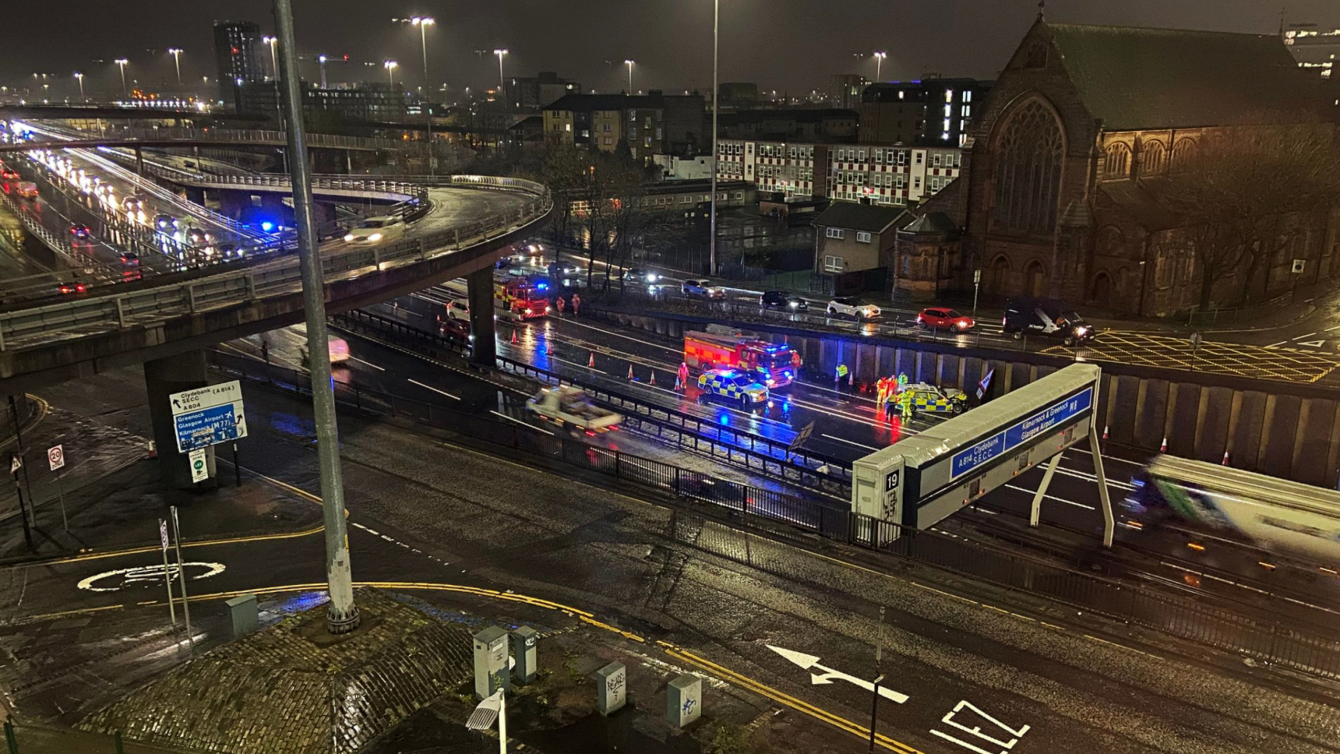 The driver of a police car is in hospital after crashing into a wall after colliding with another vehicle on the M8 motorway in Glasgow.