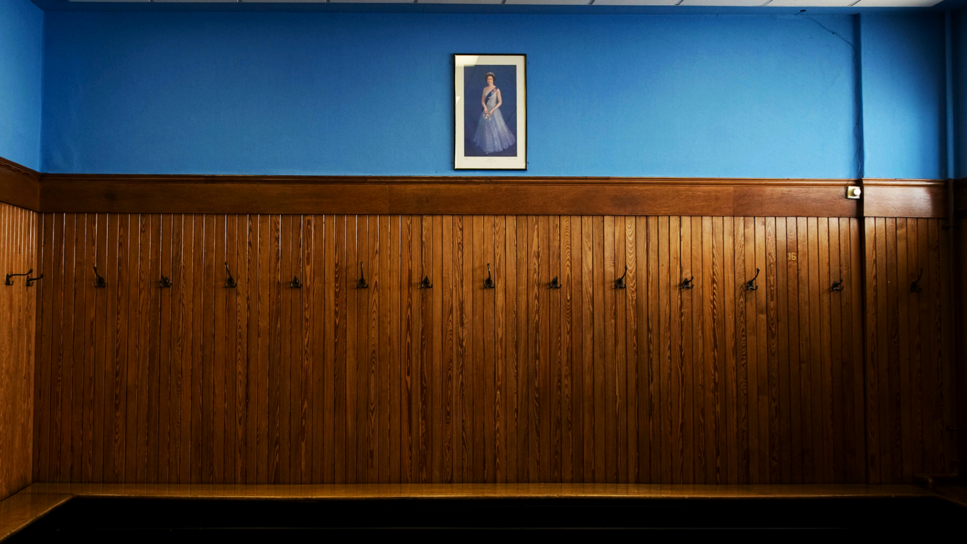 The home dressing room at Ibrox, home of Rangers Football Club, with a portrait of Queen Elizabeth hanging on the wall.